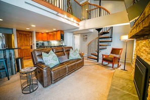 Living Room with spiral staircase and couch