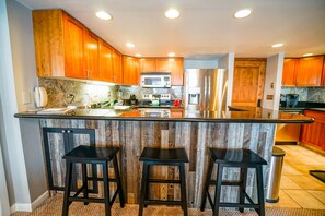 This condo for rent in steamboat Springs Colorado features a kitchen with island seating