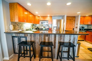 This condo for rent in steamboat Springs Colorado features a kitchen with island seating