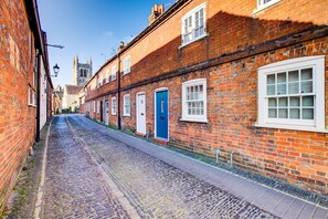 Cobbled street leading to cottage entrance