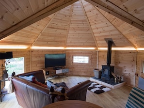 Lounge with log burner and large curved television