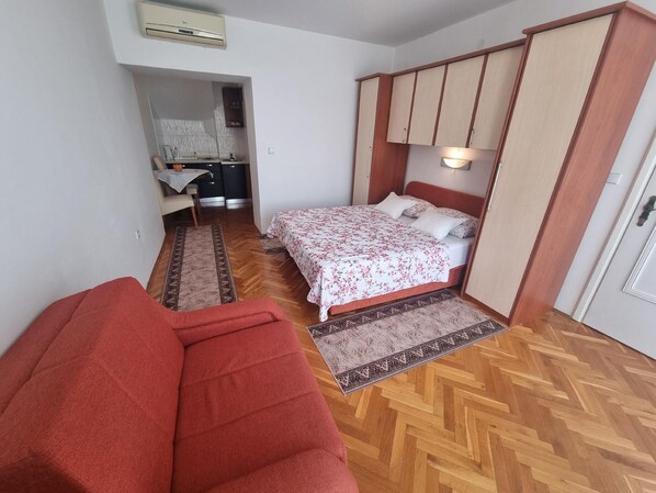 double bed, dining area and kitchenette - all in the same room