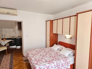double bed, dining area and kitchenette - all in the same room