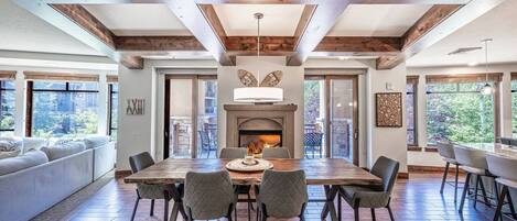 Stunning formal Dining Area with large table that has seating for 6 guests and a cozy fireplace.