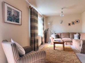 Unwind in our tranquil living room, boasting serene garden views, a smart TV with Freeview, a CD player for musical enjoyment, and a book exchange library, alongside a comfortable dining area.