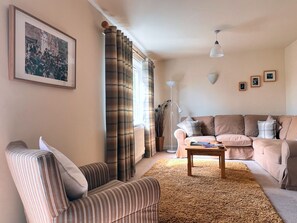 Unwind in our tranquil living room, boasting serene garden views, a smart TV with Freeview, a CD player for musical enjoyment, and a book exchange library, alongside a comfortable dining area.