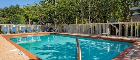 Large heated swimming pool and poolside loungers