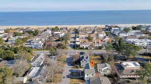 Aerial view that shows how close the home is to the ocean and beach entrance.