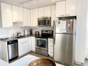 Kitchen is fully stocked for guest cooking. Includes a regular coffee maker, dishware and cookware, fridge, stove, microwave and dishwasher