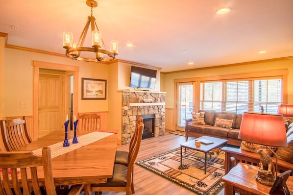 Our living room, dining area, and kitchen blend together seamlessly to create a warm and inviting space that's perfect for entertaining.