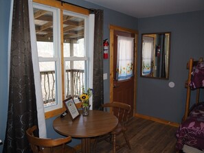 MAIN ROOM:  The main room, which features 6 beds (5 twins and 1 double), a small dining table, and a small sink / kitchenette.