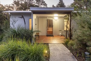 Sheltered front entrance. with security screen door and sensor lights. 
