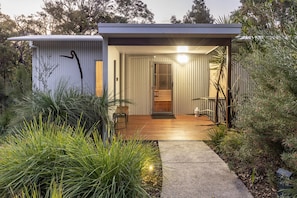 Sheltered front entrance. with security screen door and sensor lights. 