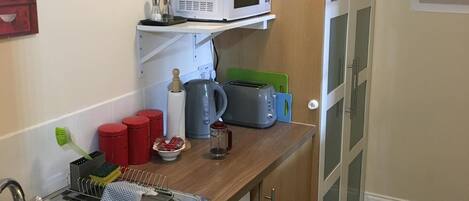 Kitchenette and store cupboard