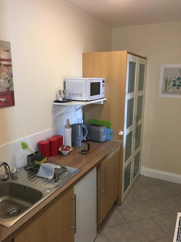 Kitchenette and store cupboard