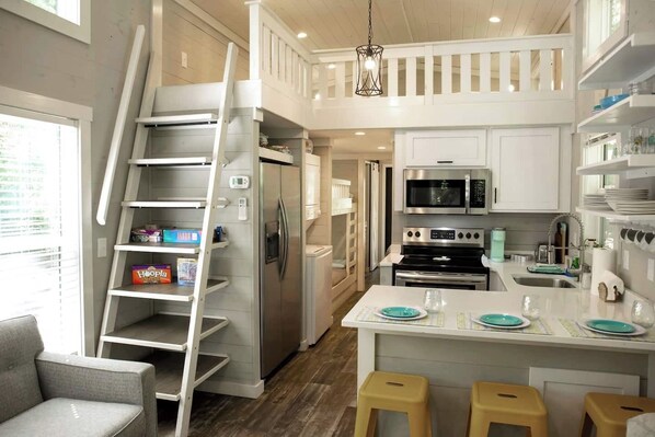 Luxury kitchen with quartz countertops and full size stainless steel appliances. 