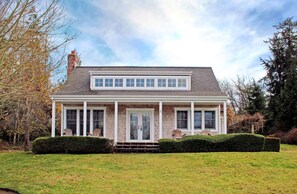 guest house with porch and adirondacks
