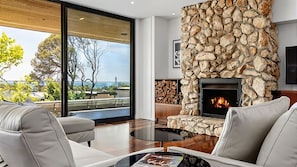 Stylish soft leather couches around the fireplace and flat-screen TV.