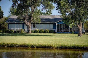 Backyard facing the lake with beautiful windows