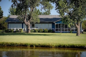 Backyard facing the lake with beautiful windows