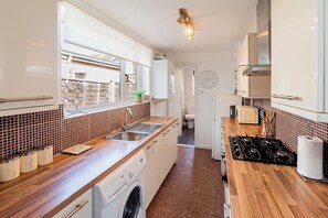 Kitchen: Bright and airy space with modern appliances and a delightful view for culinary creativity!