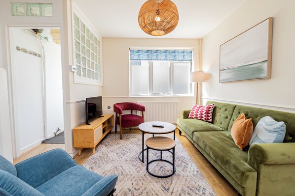 Living Room: Vibrant decor and natural light create the perfect spot to unwind after adventures!