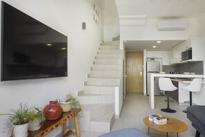  The living space comes equipped with a large wall mounted TV