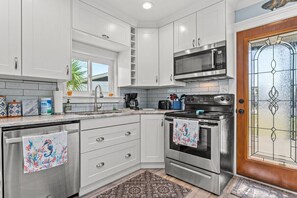 Fully stocked kitchen with granite counter tops and new appliances.