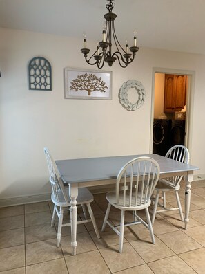 Dining table conveniently in kitchen with bench and chair seating. 