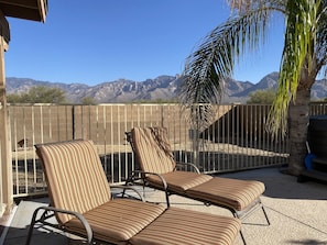 View of mountains from pool deck and hot tub.