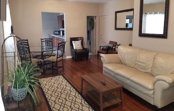 Large Living room with soft leather coach and Smart Tv connected to the free fast wifi