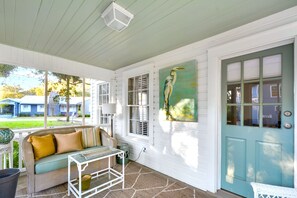 Screened Front Porch with Lounge Seating - This St. Simons vacation rental makes a first impression with its classic screened porch—perfect for coffee, cocktails, or plotting your next move after crushing crab cakes at Barbara Jean’s.