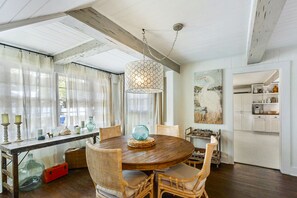 Dining Area with Bay Window and Table for Eight - This St. Simons Island vacation rental features a light-filled dining space with a bay window, perfect for takeout, seafood feasts, or long conversations after beach sunsets.