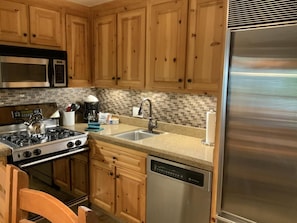 Kitchen with Sub-Zero fridge, dishwasher, garbage disp., gas range and micro