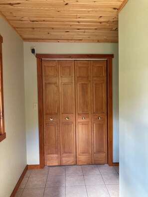 Entryway hallway with upstairs bathroom on right. 