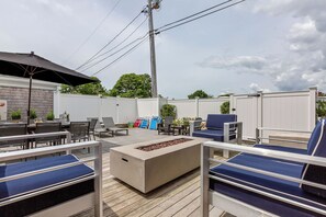 Private backyard, with three different seating areas, electric fire pit & grill.
