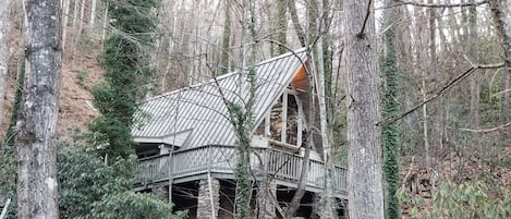 Beautiful updated original chalet sets high above ever-flowing creek in yard