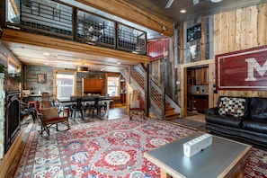 Living room, dining area, and stairs to open sleeping loft.