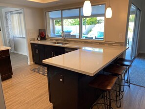 look out to pool from kitchen.  Pass-through window to outdoor eating bar