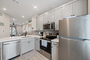 This cheerful kitchen packs everything you need for vacation cooking magic complete with new stainless appliances and a drip coffeemaker