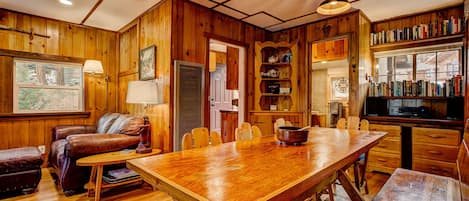 Open living space, large dining table and restored 100 year old wood floors.