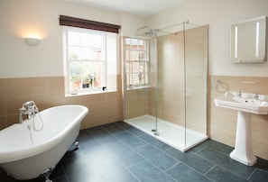 First floor: Bathroom with elegant roll top bath and separate shower