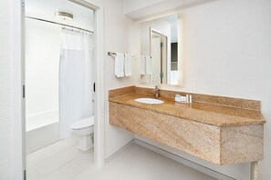 Bathroom with shower and tub. Basic toiletries and towels are provided