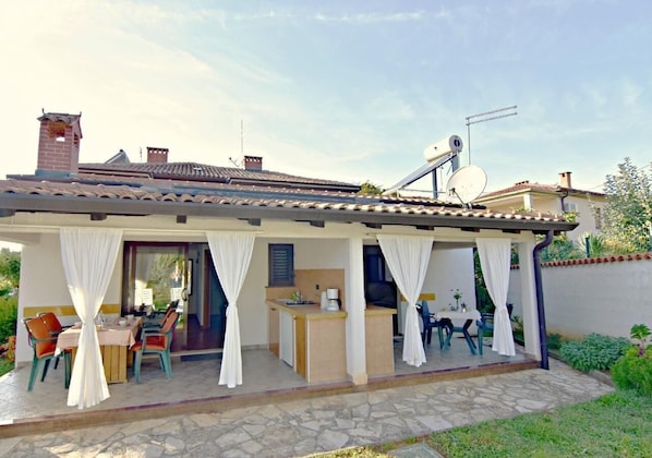 The exterior of the apartment, the terrace, and the adjacent apartment.