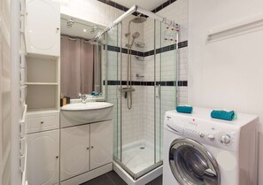 Salle de douche : douche + meuble simple vasque + lave-linge