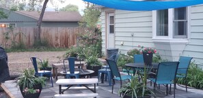 The patio invites you to relax and enjoy...grill, fire-pit, sunshade, lighting.