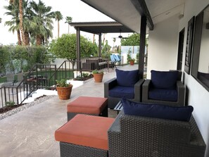 Patio outside of master bedroom with lounge chairs for enjoying morning coffee.