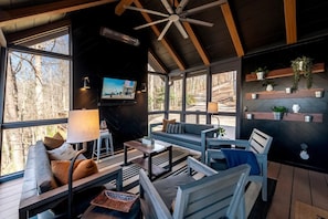 The screened-in porch is the perfect place to relax with friends