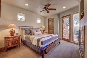 King-sized bed with walk-in closet, gas fireplace, tv & door to front courtyard.