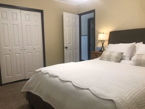 Queen bed with new luxury mattress and linens.